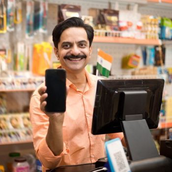 Owner at checkout counter in supermarket